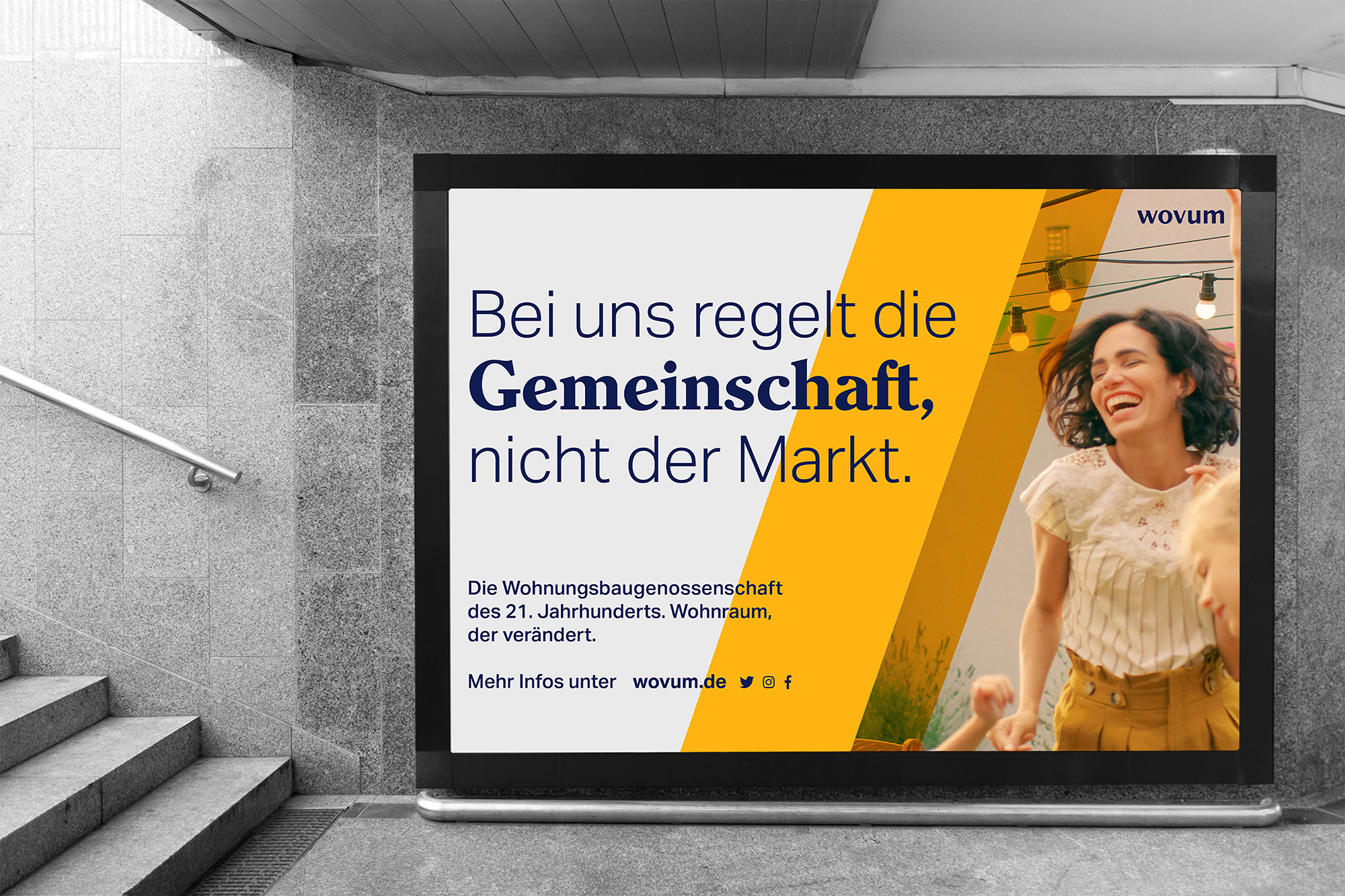 The image shows a photograph of a wovum billboard in a subway station entrance.